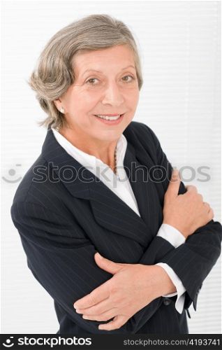 Successful senior businesswoman crossed arms professional portrait watch camera
