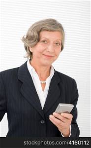 Successful senior businesswoman hold cellphone portrait