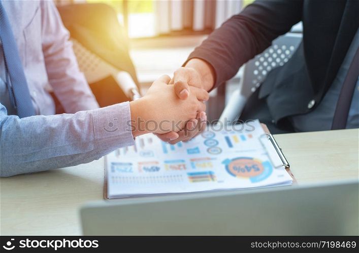 successful submit contract of two young multiracial group businessmen working in modern workplace with technology office.Business and finance concept.