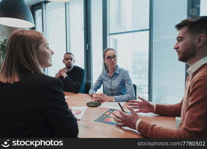 Successful team. Group of young multi-ethnic business people working and communicating together in creative office. Selective focus. High-quality photo. Successful team. Group of young multi-ethnic business people working and communicating together in creative office. Selective focus