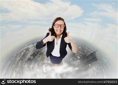 Successful woman. Top view of young pretty businesswoman with thumbs up
