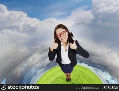 Successful woman. Top view of young pretty businesswoman with thumbs up