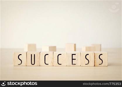 Sucess word on wooden cubes background, business concept