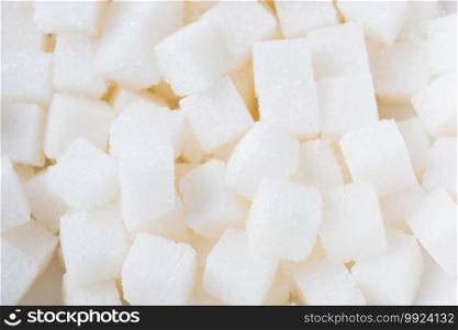 Sugar cube texture background sweet food ingredient, studio shot health high blood risk of diabetes, and calorie intake concept