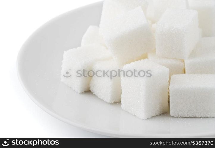 Sugar cubes in saucer on white background