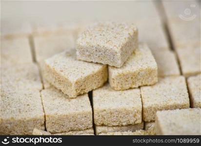 Sugar cubes on table background / Close up of brown sugar stacked in box , selective focus