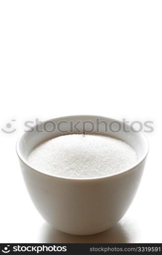 Sugar in a bowl isolated on white