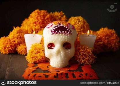 Sugar skull with Cempasuchil flowers or Marigold and Papel Picado. Decoration traditionally used in altars for the celebration of the day of the dead in Mexico