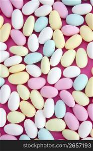 sugared almond sweet candy pastel colorful on soft pink
