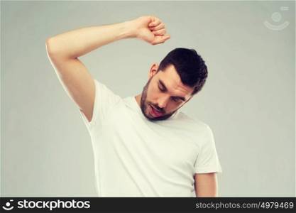 suicide, despair, death and people concept - young man making gallows or hanged gesture over gray background. young making gallows gesture over gray background