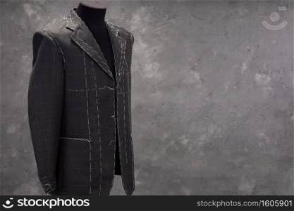 suit jacket on male tailor mannequin, creative concept of clothes atelier