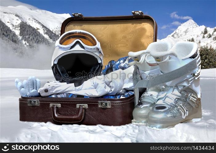 suitcase in the snow and winter sports equipment