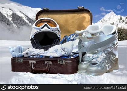suitcase in the snow and winter sports equipment
