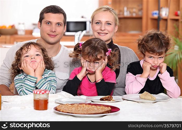 Sulky children with pancakes