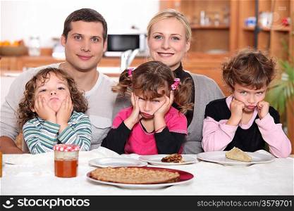 Sulky children with pancakes