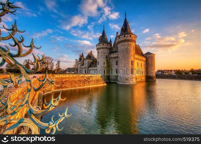 Sully Sur Loire, France - April 13, 2019: Famous medieval castle Sully sur Loire at night, Loire valley, France. The chateau dates from the end of the 14th century and is a prime example of medieval fortress.