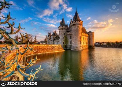 Sully Sur Loire, France - April 13, 2019: Famous medieval castle Sully sur Loire at night, Loire valley, France. The chateau dates from the end of the 14th century and is a prime example of medieval fortress.