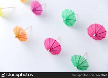 summer, accessory and decoration concept - cocktail umbrellas on white background. cocktail umbrellas on white background