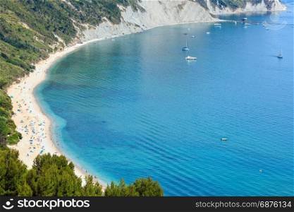 Summer Adriatic sea bay and Spiaggia Mezzavalle beach near Portonovo and Ancona towns in the Marche region. Italy, Conero Riviera. People unrecognizable.
