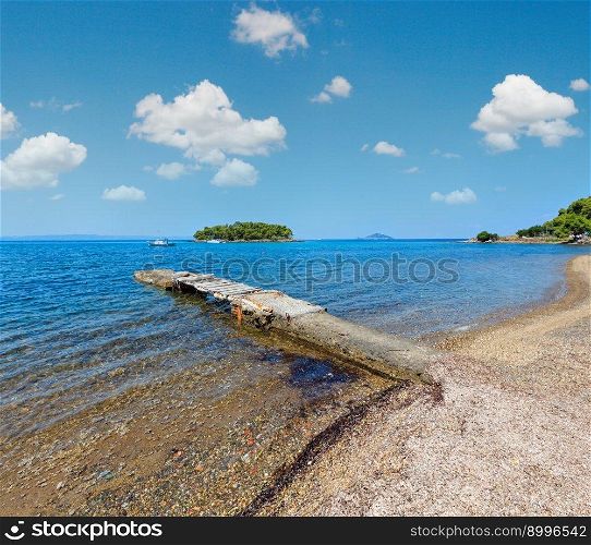 Summer Aegean Sea coast landscape with beach and old pier  Sithonia, Halkidiki, Greece .