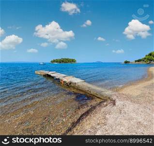 Summer Aegean Sea coast landscape with beach and old pier  Sithonia, Halkidiki, Greece .