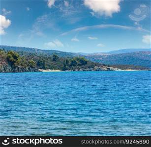 Summer Aegean Sea coast landscape with beaches (Sithonia, Halkidiki, Greece). People unrecognizable.