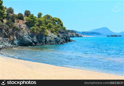 Summer Aegean Sea coast landscape with sandy beach (Sithonia, Halkidiki, Greece). People unrecognizable.