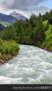 Summer Alps cloudy evening mountain landscape with alpine river, Silvretta Alps, Austria