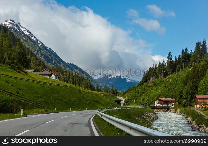 Summer Alps mountain landscape with alpine river and road (Silvretta Alps, Austria).