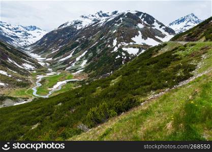 Summer Alps mountain landscape with alpine road and river (Fluela Pass, Switzerland)