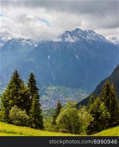 Summer Alps mountain landscape with yellow wild flowers on grassland slope, Switzerland.