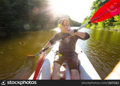 summer and active sport. a man kayaking in sunset time