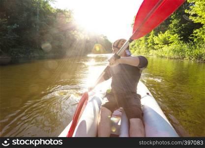 summer and active sport. a man kayaking in sunset time