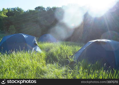 summer and active sport. tents stand in a meadow