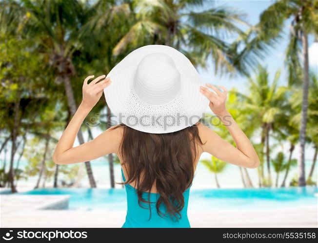 summer and holiday concept - model in swimsuit with hat