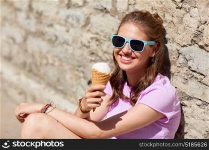summer and people concept - happy young woman eating ice cream on street. happy woman or teen girl with ice cream in summer