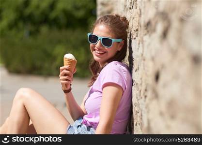 summer and people concept - happy young woman eating ice cream on street. happy woman or teen girl with ice cream in summer