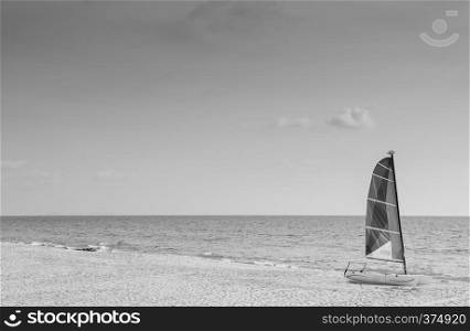 Summer at Bakantiang beach with sailboat against sun in Koh Lanta with clear sky - Krabi, Thailand. Black and white image