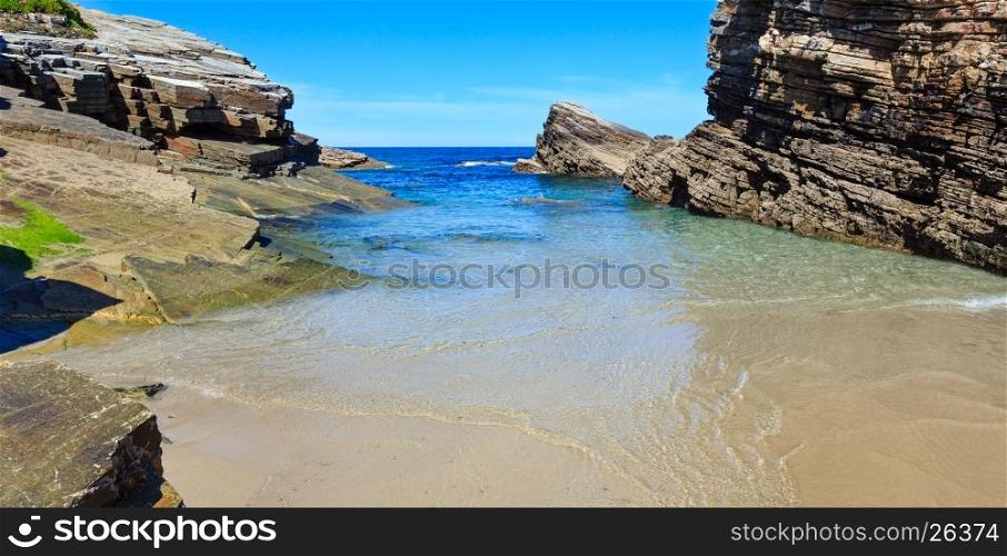 Summer Atlantic coast landscape with beach and rock formations (Praia Das Illas, Spain).