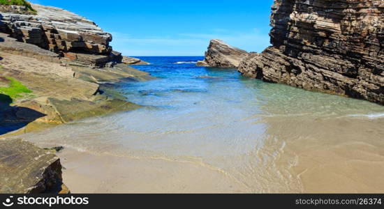 Summer Atlantic coast landscape with beach and rock formations (Praia Das Illas, Spain).