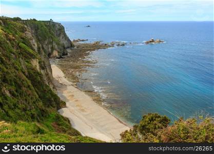 Summer Atlantic ocean coast with Churin beach and rock formations. View from Regalina promontory, Cadavedo, Asturias, Spain.