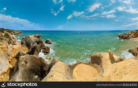 Summer Atlantic rocky coast view  Albufeira outskirts, Algarve, Portugal . Three shots stitch high-resolution panorama.