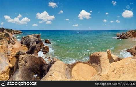 Summer Atlantic rocky coast view  Albufeira outskirts, Algarve, Portugal . Three shots stitch high-resolution panorama.
