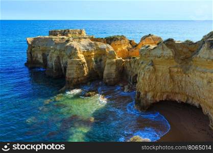 Summer Atlantic yellow rocky coast top view (Albufeira outskirts, Algarve, Portugal).