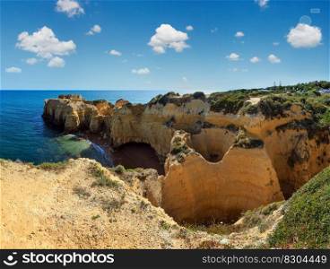Summer Atlantic yellow rocky coast top view  Albufeira outskirts, Algarve, Portugal . Two shots stitch panorama.