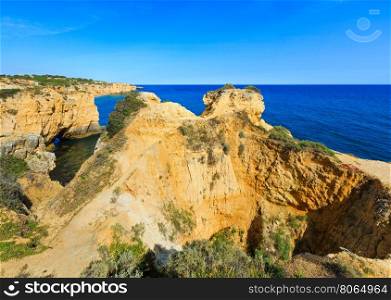 Summer Atlantic yellow rocky coast view (Albufeira outskirts, Algarve, Portugal).