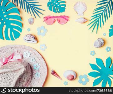 Summer background. Beach accessories with shells and tropical leaves on light yellow background, top view. Straw hat and sunglasses. Summer holiday vacation. Female fashion outfit . Flat lay