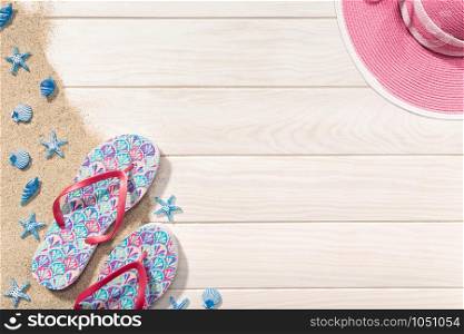Summer background. White Wooden background with flip flops, sand, seashells and hat. Vacation or beach concept