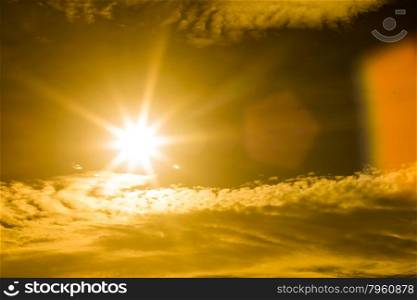 Summer background with a magnificent sun burst with lens flare. ( Hot white balance for warm feeling)