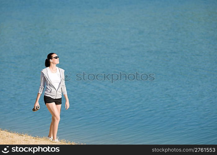 Summer beach active woman walk on beach in fitness outfit